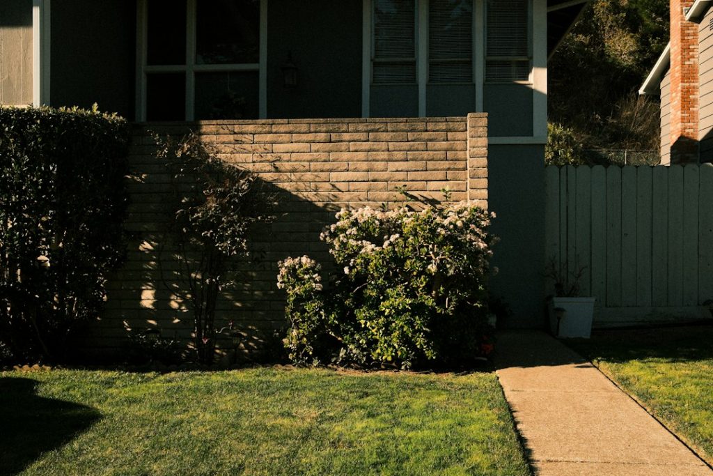 Suburban home and lawn representing electrical diagnosis of a sprinkler zone that will not operate