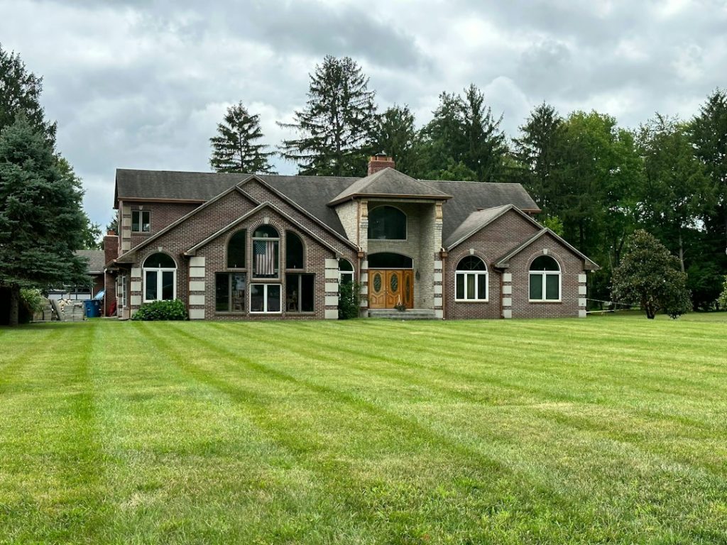 Residential home and lawn representing diagnosis of a sprinkler valve operating problem