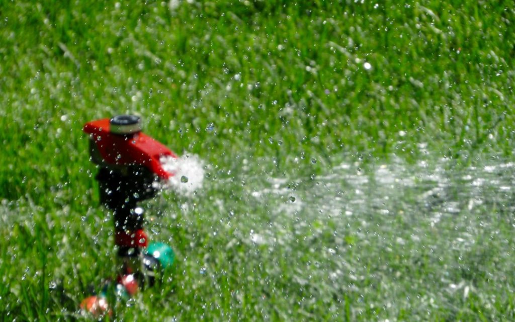 Lawn sprinkler illustrating spray pattern and sprinkler head adjustment