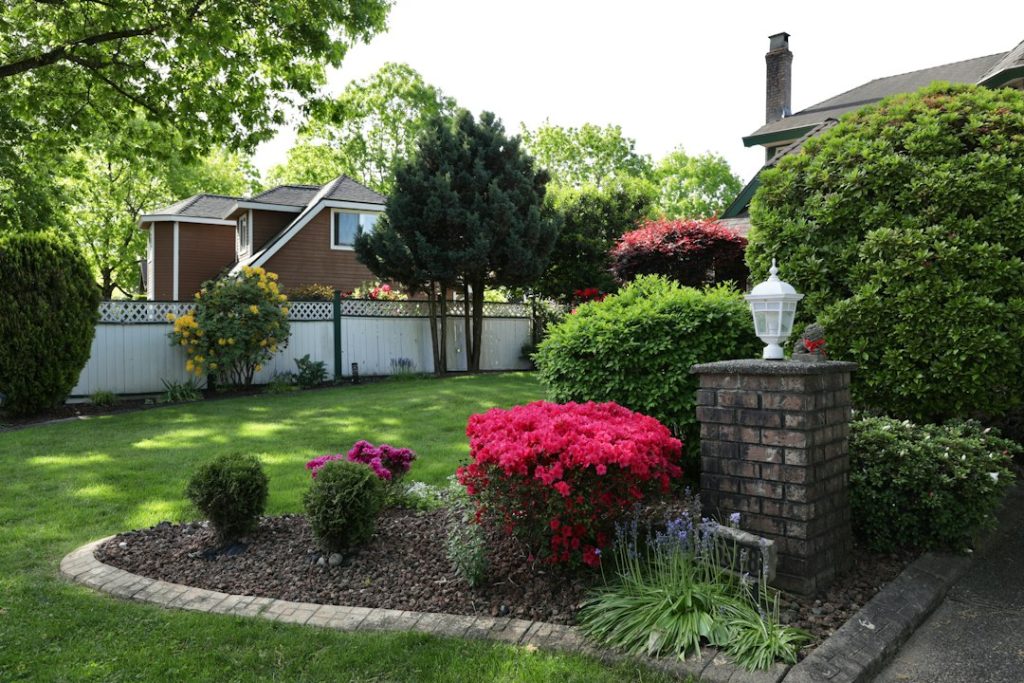 Well-maintained residential landscape illustrating seasonal sprinkler system inspection