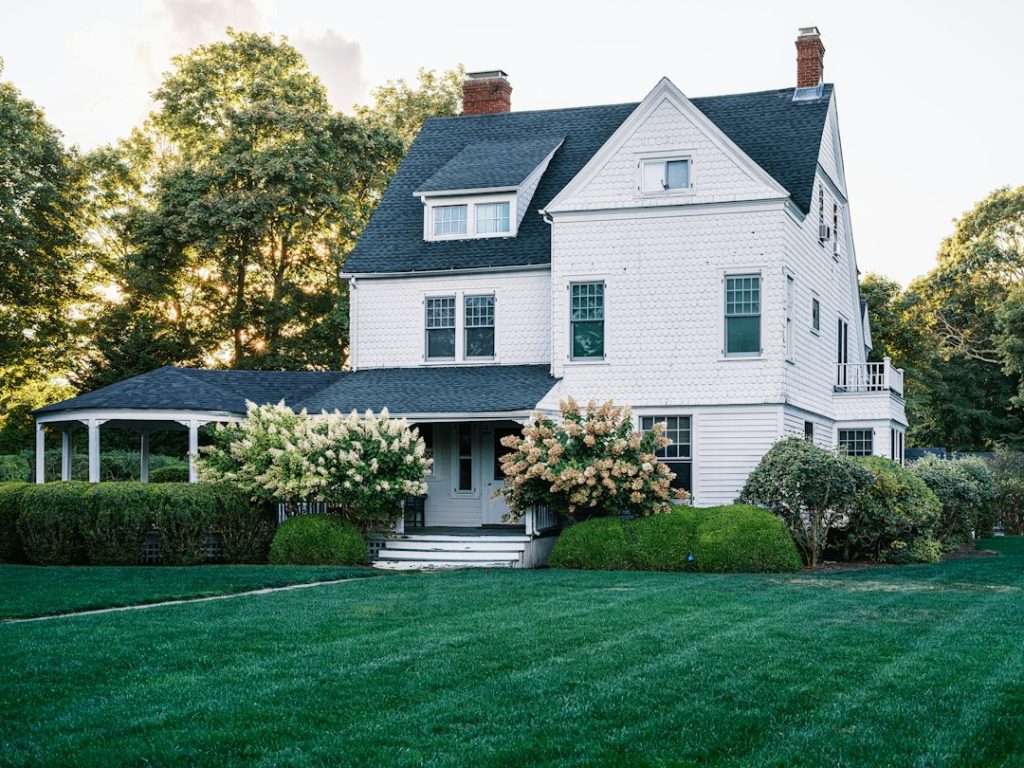 Landscaped home and lawn illustrating sprinkler zone runtime and watering schedules